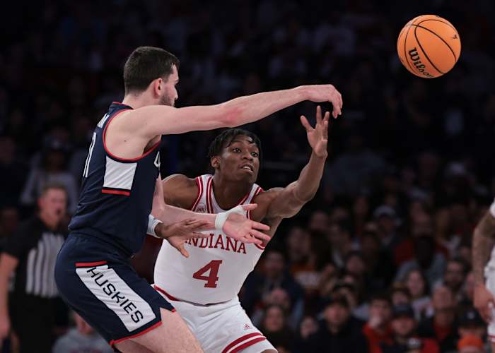 Connecticut Huskies forward Alex Karaban (11) passes the ball as Indiana Hoosiers forward Anthony Walker (4) defends during the second half at Madison Square Garden.